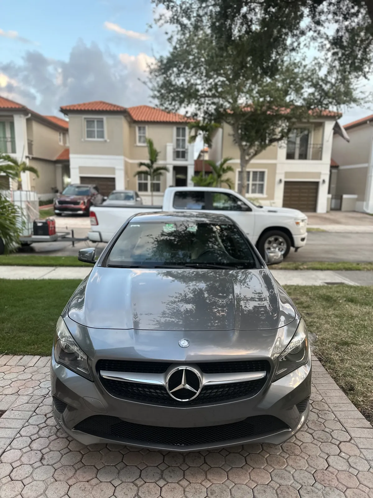 Gray Mercedes-Benz photographed from the front in a residential driveway