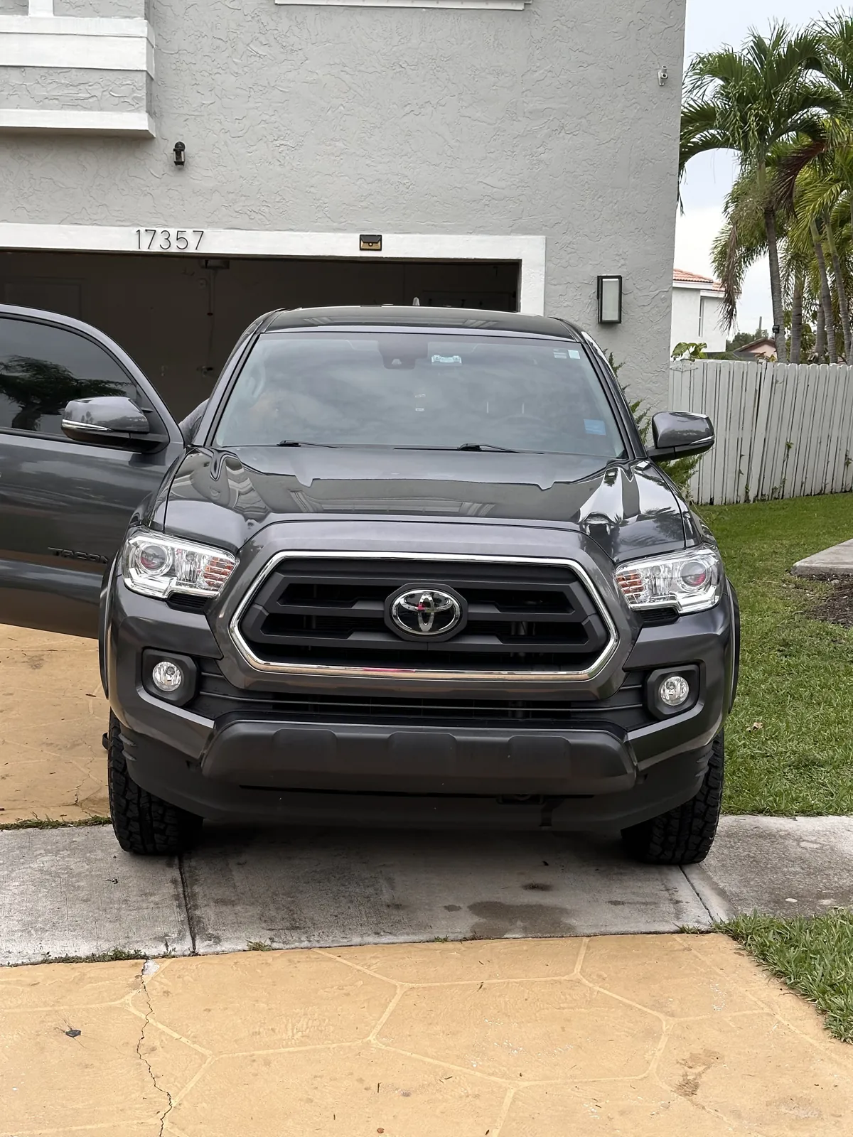 Dark gray Toyota Tacoma photographed from the front outside a home